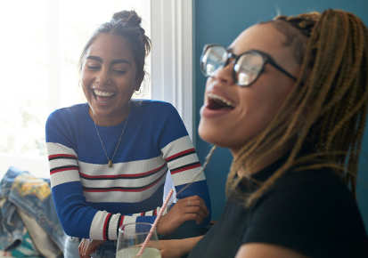 Two teenage girls laughing 