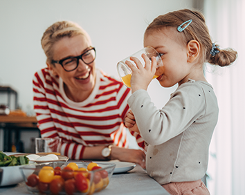 Mother with toddler drinking juice