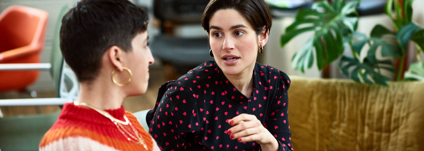 Two colleagues discussing neurodiversity at work