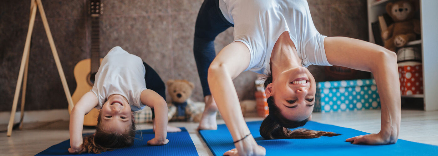 woman and daughter doing stretches
