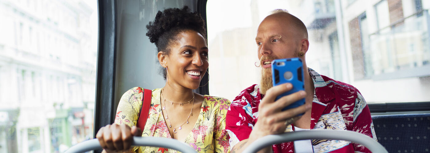 Young man and woman commuting on the bus