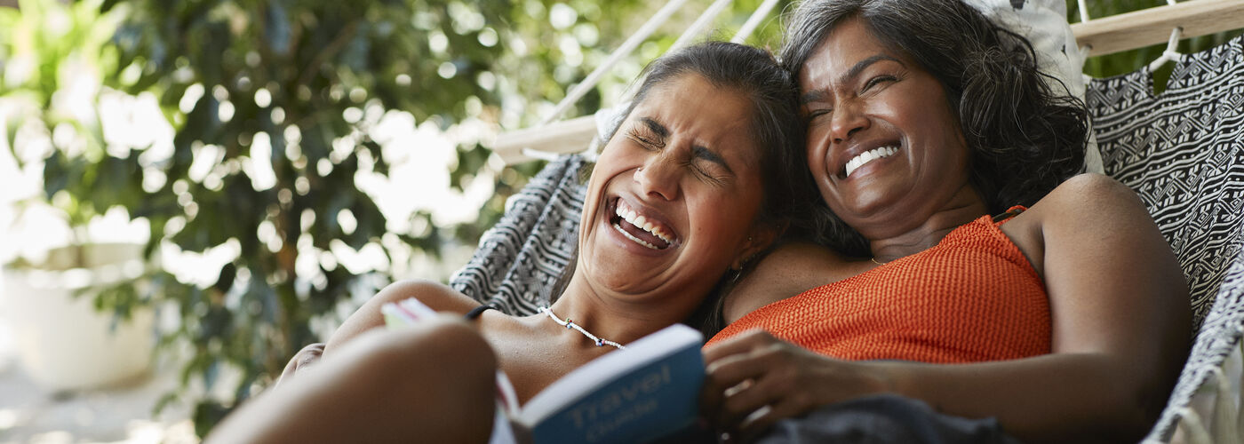 Two ladies in a hammock laughing