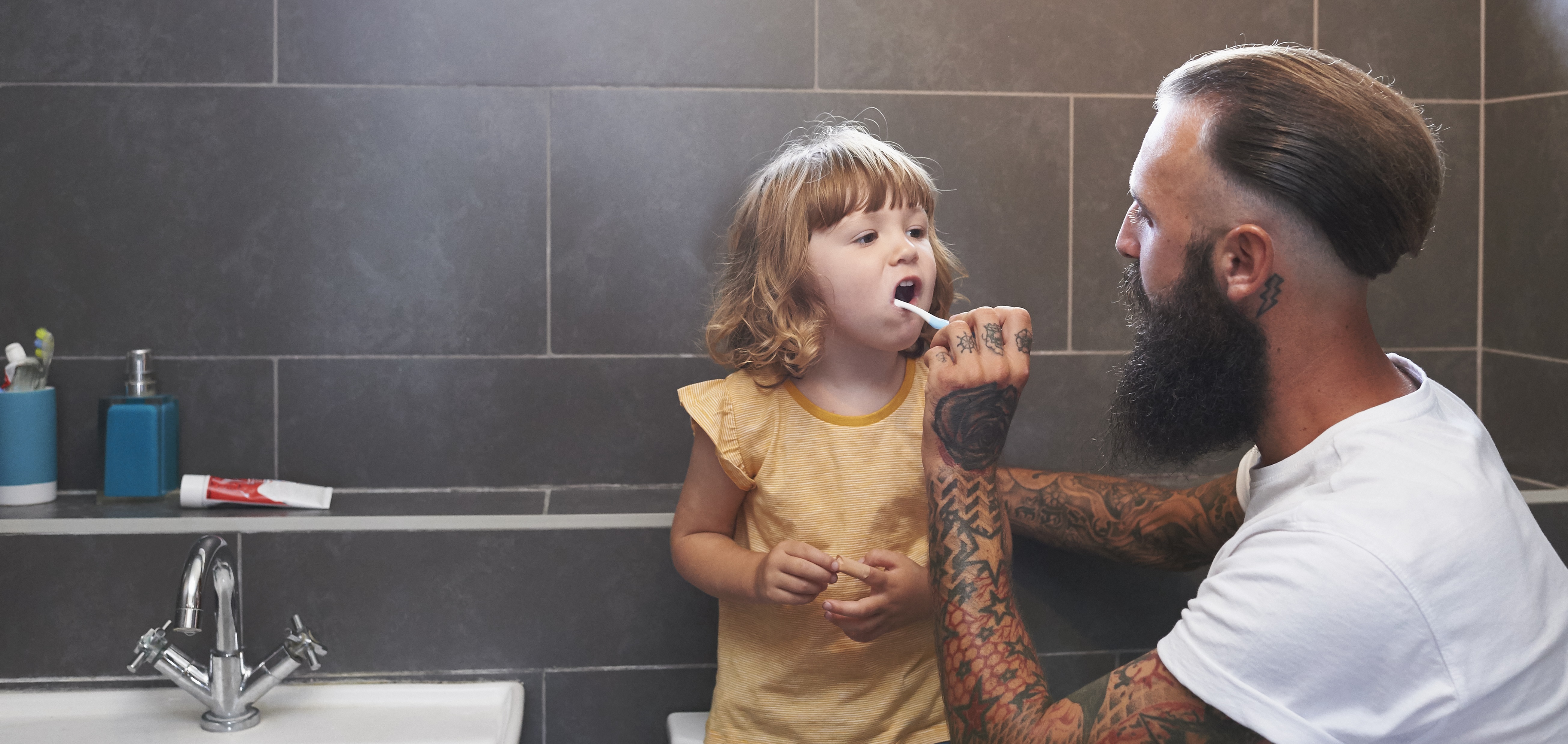 Dad brushing daughter's teeth