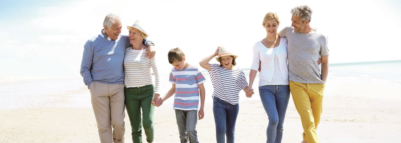 Image of extended family walking on the beach