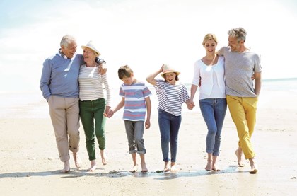 Image of extended family walking on the beach