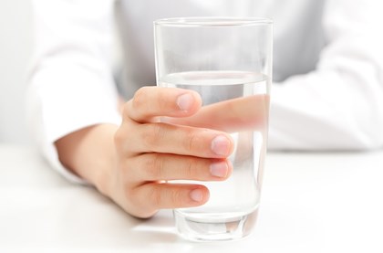 office employee holding a glass of water