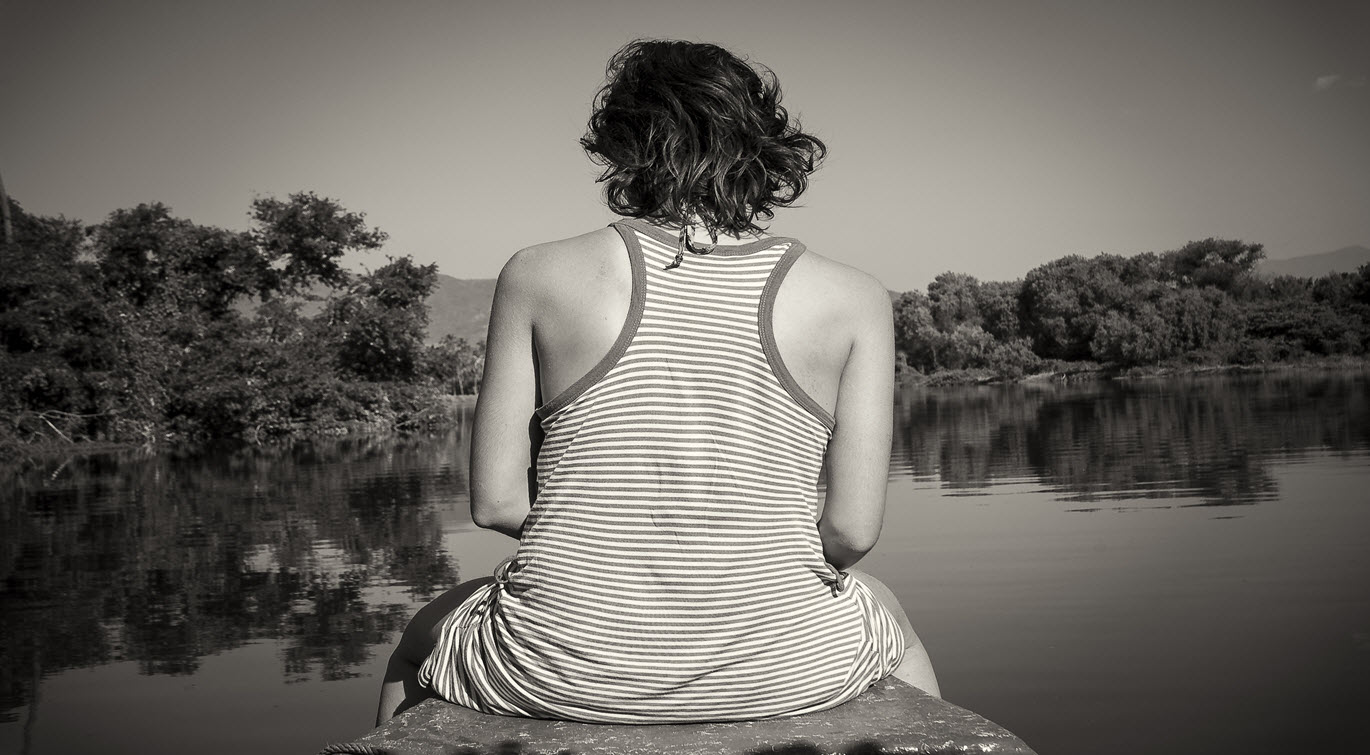 woman-relaxing-on-the-prow-of-a-boat-while-slowly-cruising