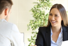 Male job candidate shaking hands with female employer at a job interview Male job candidate shaking hands with female employer at a job interview