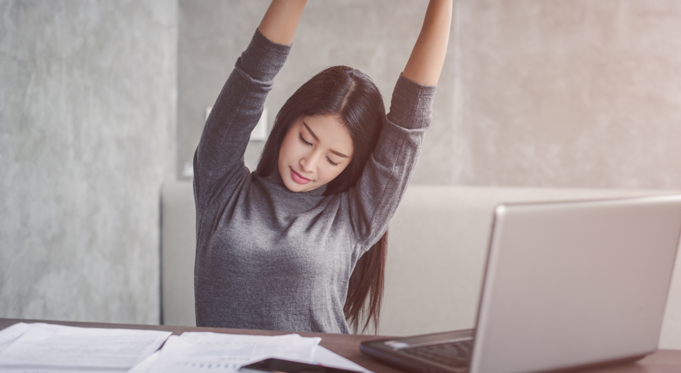 businesswoman stretching at her desk