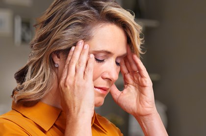 Woman struggling with migraine symptoms