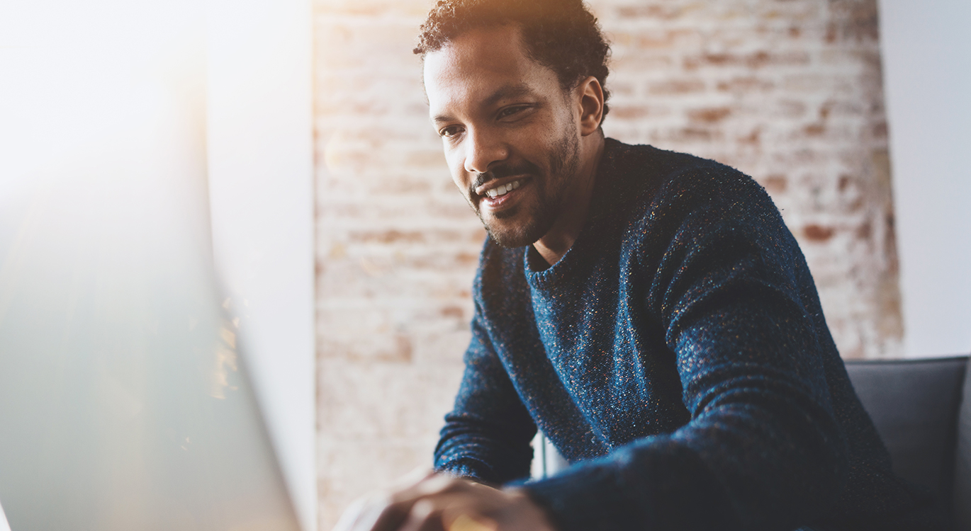 Man accessing an online GP service from home