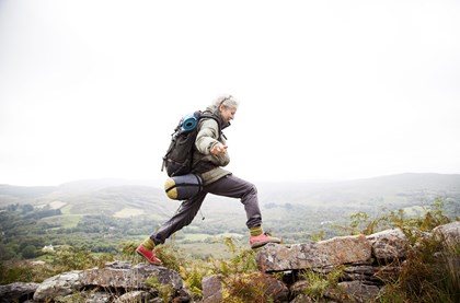 exercise can help you to manage arthritis, image of older woman on a country walk