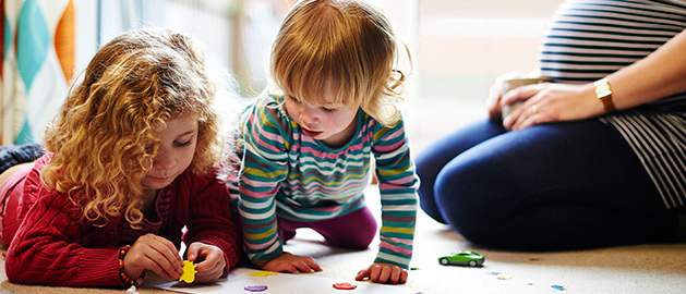 two young children playing on floor