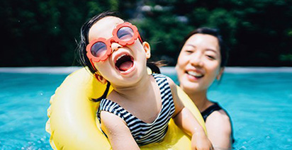 Young girl and Mum in swimming pool 