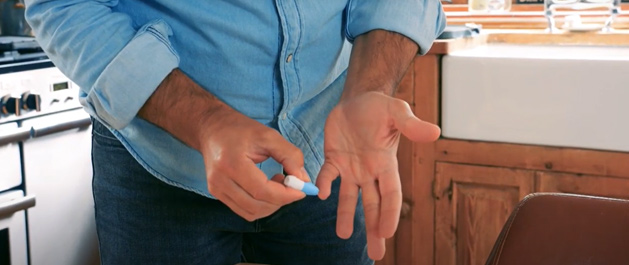 Person taking their blood sample at home