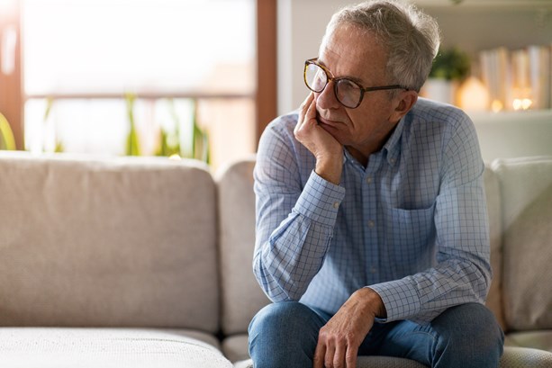 Mental health - Sad middle aged man sitting alone 