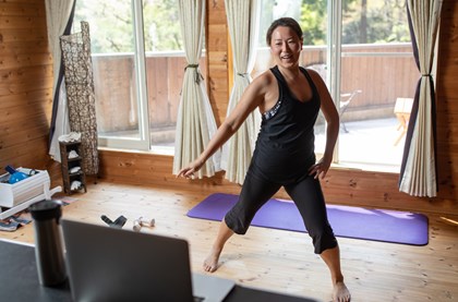 A mid-aged woman exercising at home