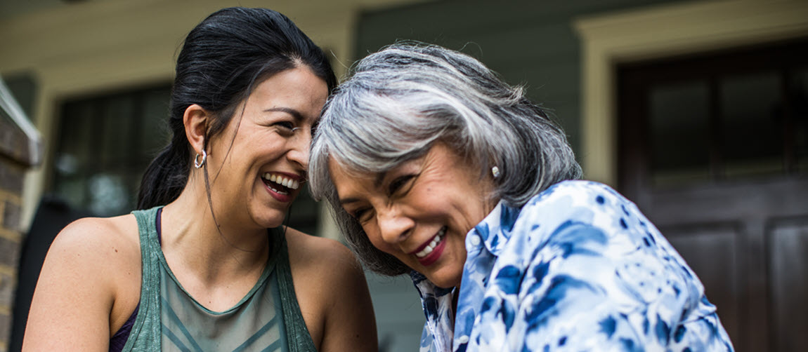 A woman and her daughter sat on their porch laughing 