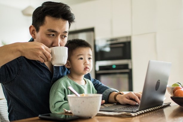 Man balancing childcare and working from home