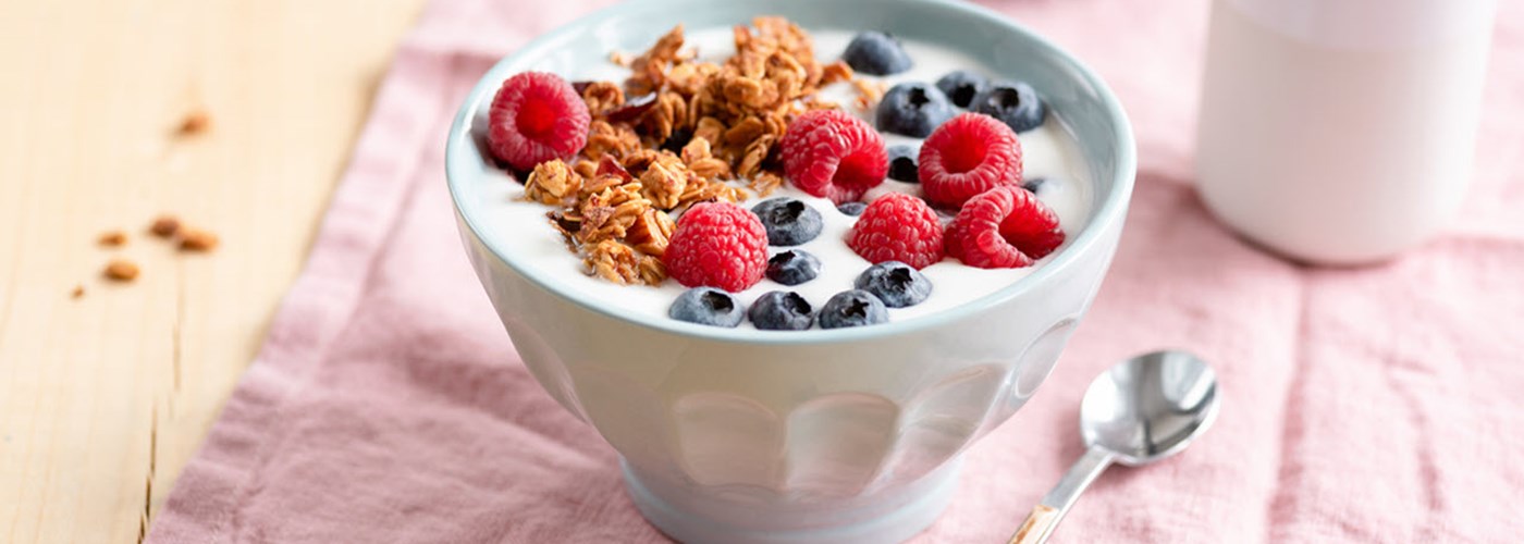 Duck egg blue bowl of granola with yoghurt, raspberries and blueberries 