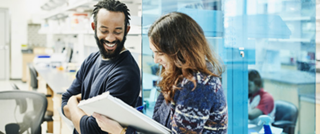 Two colleagues running through a report
