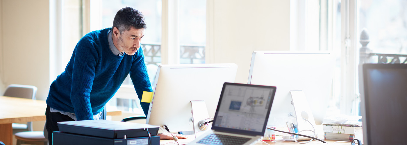 A man in an office working alone 