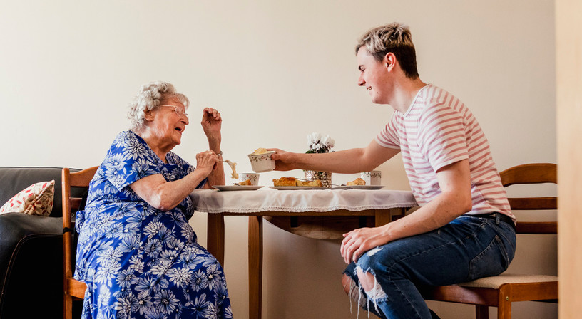 Young employee visiting his grandma who he cares for
