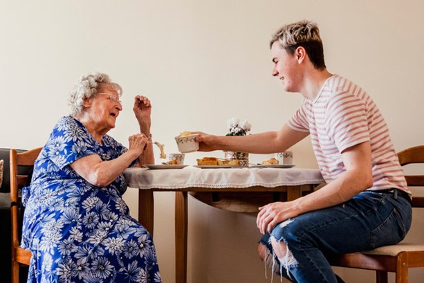 Young employee visiting his grandma who he cares for