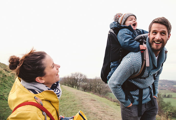 Young couple out walking with a baby 