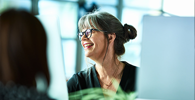 Photo of a mature lady smiling, working in an office