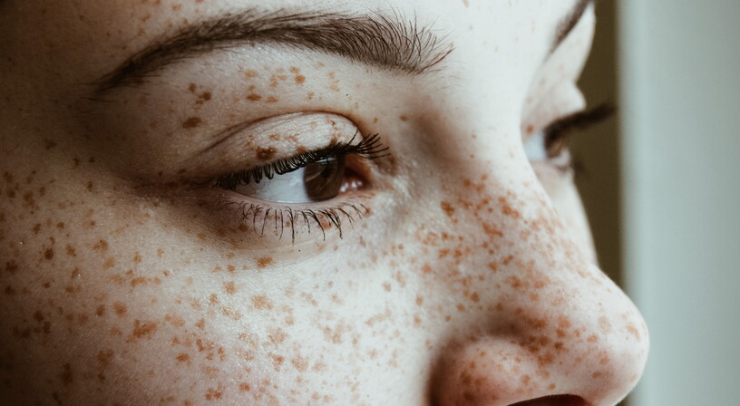 Close up of hazel eyed woman looking away