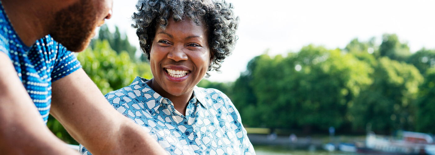 middle aged woman with grey hair smiling at man
