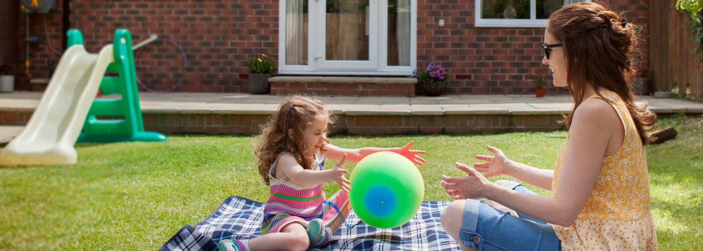 Mother and Daughter Playing in Garden in the summer