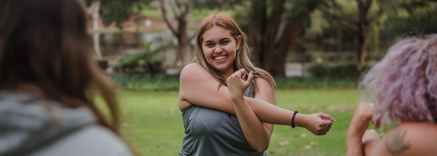 Young lady stretching exercising outdoors