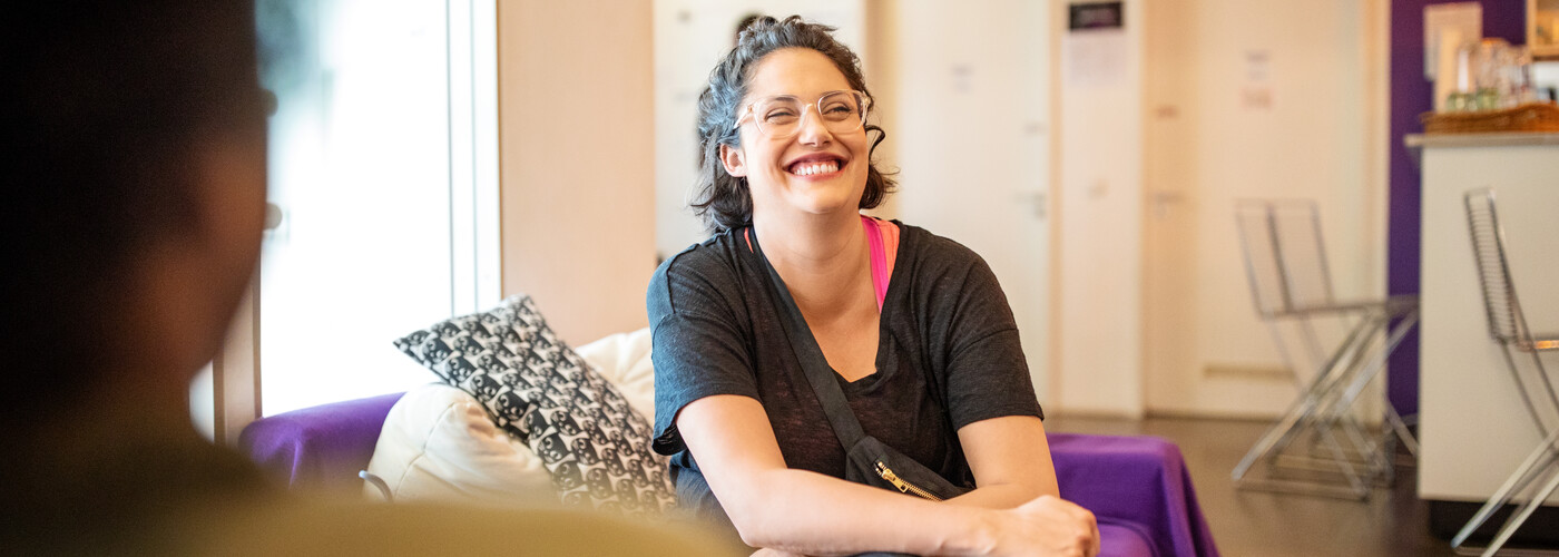 Lady smiling covering her stomach