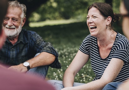 Friends laughing outside picnic