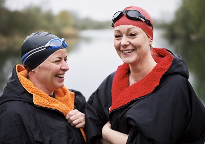 Two ladies bundled up after wild swimming Two ladies bundled up after wild swimming