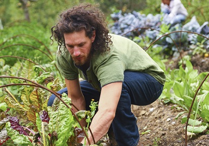 A man with psoriasis gardening outside