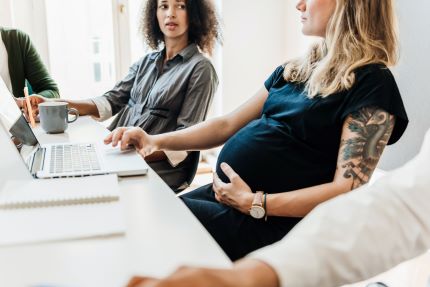 Pregnant woman in a work meeting