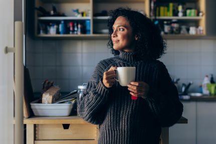 woman drinking tea in her home