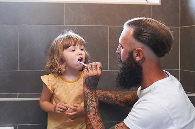 Cash Plan claim - Father brushing toddler's teeth