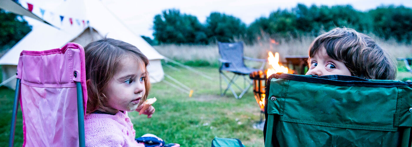 Children sat in front of bonfire