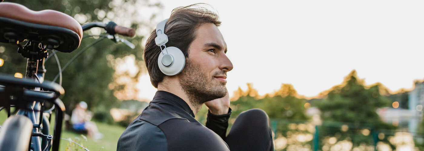Young man peacefully sitting on a park bench