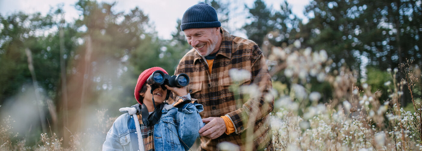 Grandad and grandson exploring outdoors