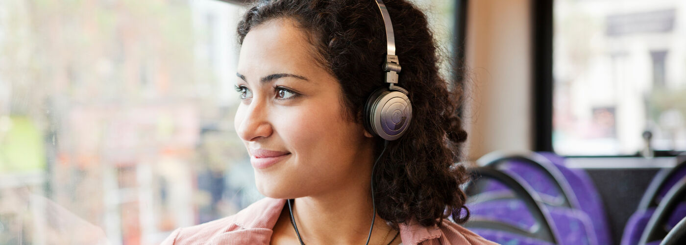 woman looking out of the window on a bus