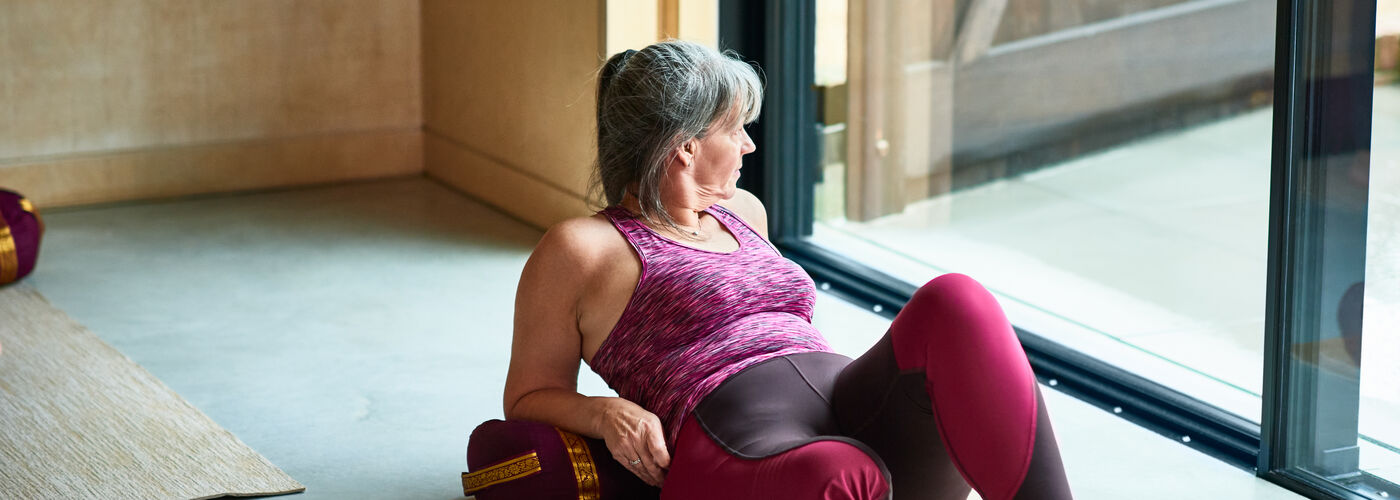 Female working out, looking away absent mindlessly